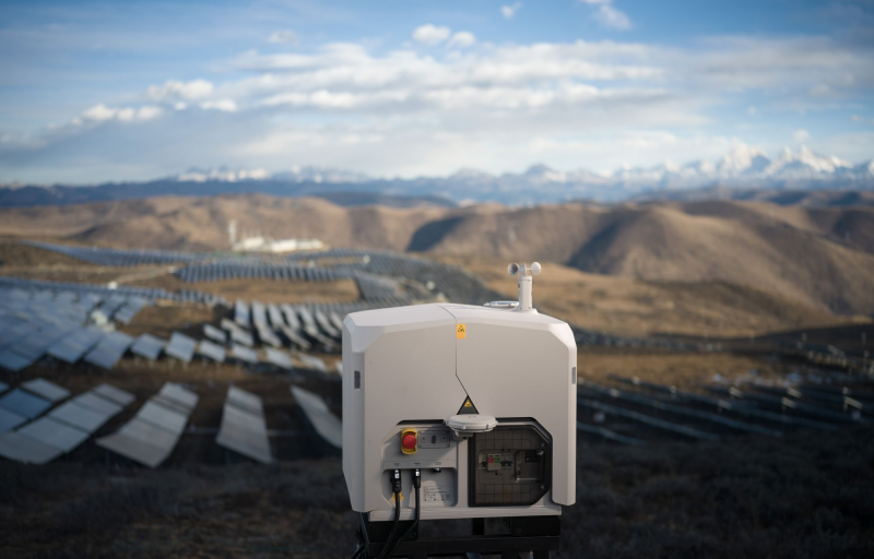 DJI Dock 3 in front of solar panels with mountains in the background